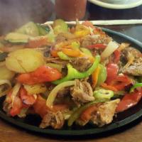 Pork Fajitas · Chunks of tender pork, grilled with baby red potatoes, red onions and red and yellow peppers.