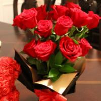 One Dozen Red Roses · One dozen red roses in floral paper wrapped foam. Bear and chocolates not included unless ad...