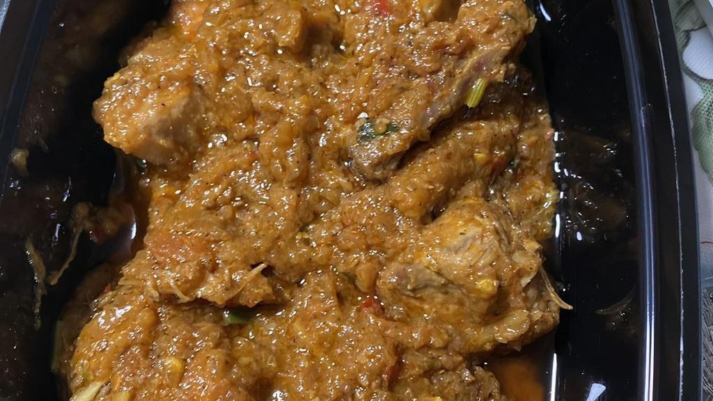Goat Karahi (2 Person) · Two naans. Goat meat with bone simmered in onions, tomatoes, and fresh ginger garlic and other spices.