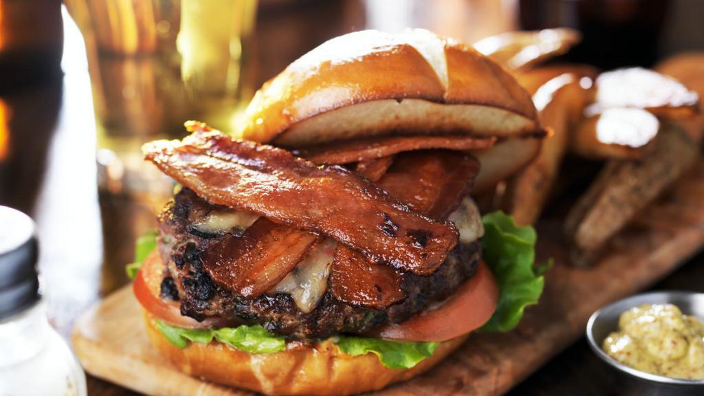 Cowboy Bbq Burger · All beef burger topped with Cheddar Cheese, Hickory BBQ sauce, Cherrywood smoked bacon, Crispy Fried Onions, lettuce, tomato, red onion, pickle.