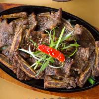 Kalbi · Thick Sliced Bone-in Beef short ribs marinated in Korean bbq sauce.
