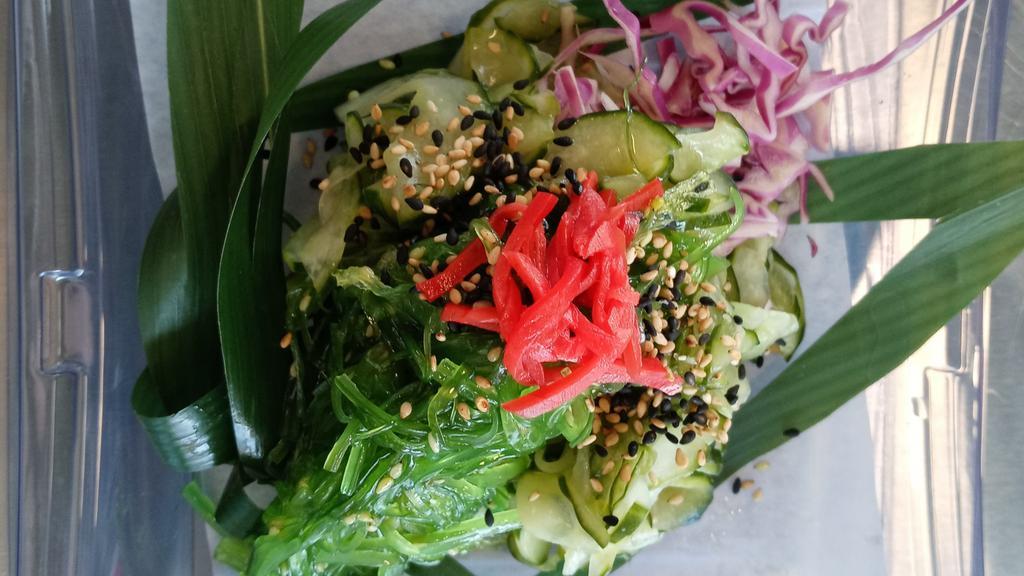 Cucumber Salad · Marinated thinly sliced cucumbers, seaweed salad & imitation crab meat dressed in a citrus soy ponzu sauce and topped toasted sesame seeds & pickled ginger on shredded purple cabbage.