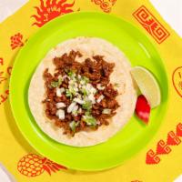 Chorizo Taco · Spicy crumbled sausage topped with cilantro and chopped onion on a soft corn tortilla.