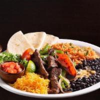 Steak Fajitas · Marinated strips of steak, sautéed with onions, green pepper & tomatoes. Served with Spanish...