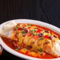 Outrageous Burrito ~ · Our biggest burrito for burrito lovers!
A large ﬂour tortilla stuffed full with Spanish rice...