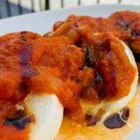 Eggplant Tablao · Fresh mozzarella, fried eggplant and warm tomato ragu.
