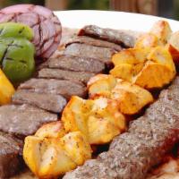 Lamb And Kubideh Kabob · One skewer of chunks of lamb and a skewer of ground sirloin. Served with grilled vegetables ...