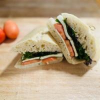 Caprese Sandwich · Fresh sliced mozzarella with tomatoes in a French roll with pesto spread, sprinkled basil an...