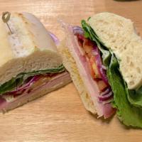 1/2 The Monster · Turkey breast, ham, Swiss cheese with crispy bacon, lettuce, tomato and onion on a French Ro...
