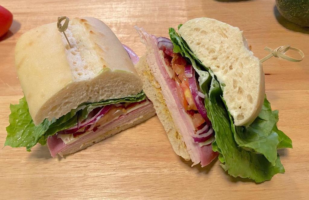 1/2 The Monster · Turkey breast, ham, Swiss cheese with crispy bacon, lettuce, tomato and onion on a French Roll with mayo and deli mustard.