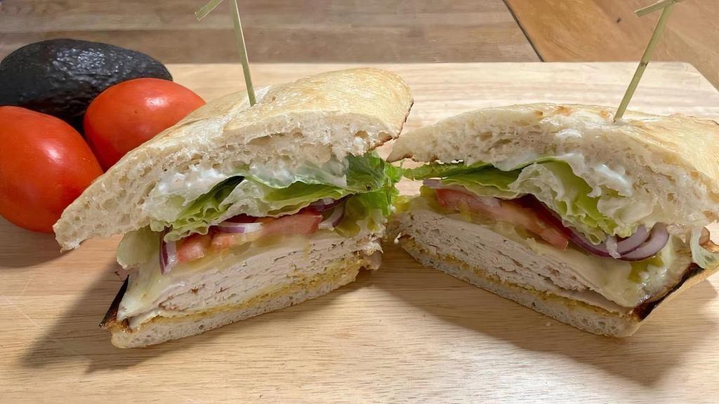Turkey Mex · Turkey breast, mild green chillies, melted pepper jack cheese, lettuce, sprouts, tomatoes and onions on a French roll with mayo and deli mustard.