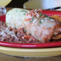 Chimichanga · Flour tortilla + choice of meat + navajo rice + smothered in tomatillo cream sauce + red chi...