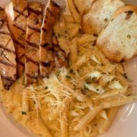 Mac-N-Cheese · Penne pasta tossed with Alfredo sauce and creamy parmesan cheese. Add your choice of meat.