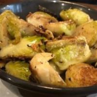Brussel Sprouts · Crispy fried brussel sprouts tossed with roasted almonds and Parmesan cheese.