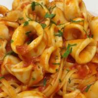 Calamari Linguini · Sauteed in a garlic, marinara wine sauce, fresh herbs over linguini.