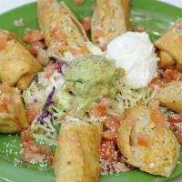 Chicken Taquitos · Two Rolled Flour Tortillas stuffed with Chicken and Jack Cheese, served Crispy. Garnished wi...
