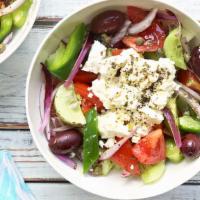 Horiatiki (Village) Salad · Tomatoes, cucumbers, green peppers, black olives, crumbled feta, pepperoncini, anchovies, ca...