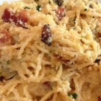 Spaghetti Carbonara · Pasta tossed with bacon, sauteed onions, eggs, and cheese.