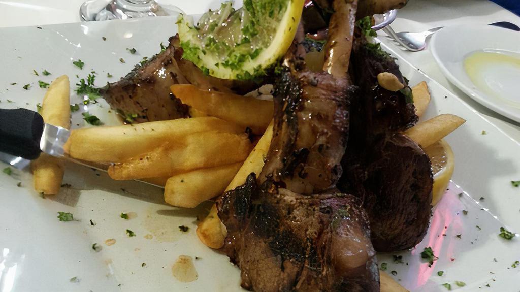 Lamb Chops · Marinated in red wine, herbs, and spices, then grilled over a charcoal flame to order.
