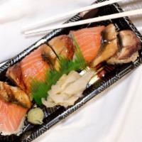 Lion King Roll · Inside: shrimp tempura, cucumber, avocado. Outside: salmon, spicy crabmeat.