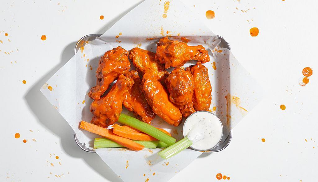 10 Piece Chicken Wings · 10 crispy, juicy all-natural wings fried to perfection and tossed in your choice of sauce. Served with celery and ranch or blue cheese.