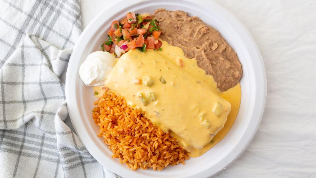 Poblanos Burrito · Taco meat or chicken, cheese and pinto beans wrapped in a large flour tortilla, topped with chili con queso. Served with rice, pinto beans, sour cream and pico de gallo. Guacamole upon request.