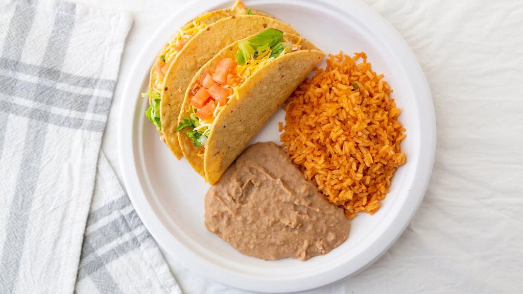 Tacos Plate · Two tacos, soft or crispy, with taco meat or chicken, lettuce, tomatoes and cheese. Served with rice and pinto beans.