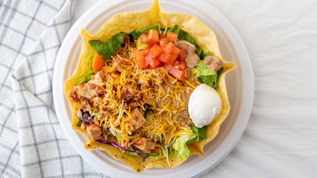Taco Salad · Crispy tortilla shell with mixed greens, pinto beans, tomatoes, seasoned beef or chicken, sour cream and shredded cheese. Guacamole upon request.