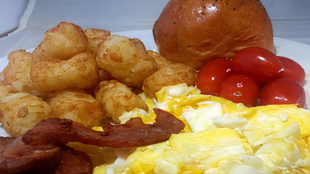 Egg  Platter  · Scrambled Egg topped with Tater Tots, Bacon, Fresh Tomatoes and a Fresh Bread