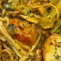 Pasta New Orleans · Blackened chicken, mushrooms, broccoli, scallions, and tomatoes, in our spicy cajun alfredo ...