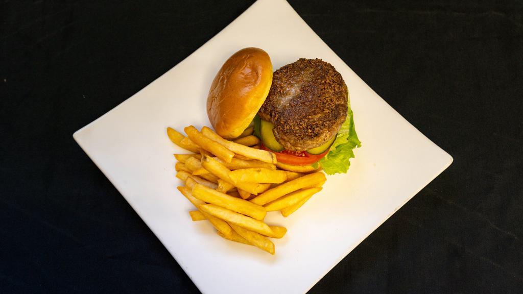 Jerk Burger · Jerk beef burger dressed with pickles, lettuce, tomatoes, and cheese. Served with a side of fries.