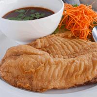 Tilapia Filet · One Tilapia filet lightly batter fried. Garnished with steamed. broccoli, and served with ou...