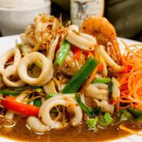 Seafood Pad Cha · Jumbo shrimp, scallops and squid stir fried in
a spicy garlic sauce with Thai herbs, celery,...