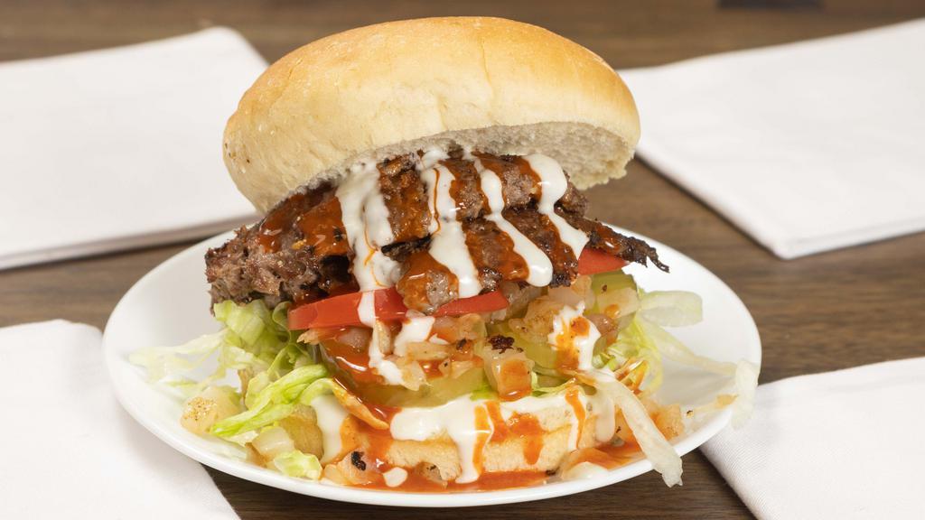 Buffalo Bleu Burger · Spicy. Double patty, buffalo sauce, bleu cheese dressing, caramelized onions, shredded lettuce, tomato, pickles.