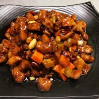 Kung Pao Chicken · Spicy. Diced chicken sautéed in a rich brown sauce, with dried hot peppers, peanuts, diced b...