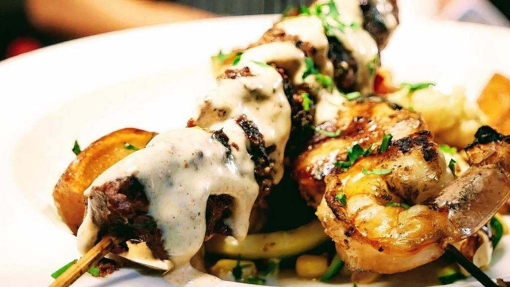 Surf & Turf · Skewer of Filet Mignon Chunks, 2 Jumbo Shrimp, 2 Jumbo Scallops, Grilled & topped with Herb Aioli, Daily Vegetables, Baby Roasted Potatoes