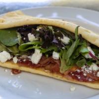 The Simba Sandwich · Prosciutto, bacon, fig and cream cheese spread goat cheese spring mix on a flat bread.
