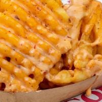 Crispy Cheese Fries · Classic waffle fries with SoB seasoning topped with queso