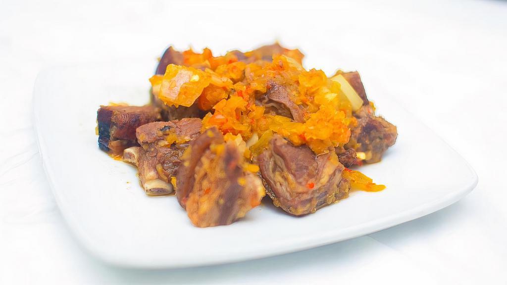 Asun (Barbecued Meat) · Marinated goat meat, chopped into bite-sized pieces, and perfectly garnished with the right amounts of onions, garlic, ginger, tomatoes, curry powder and scotch bonnet pepper.