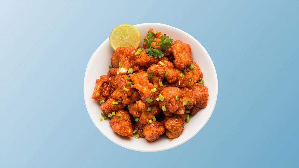 Cauliflower Manchurian Madness · Cauliflower flowerets, seasoned, batter fried and sauteed with green onions and an Indo-Chinese Manchurian sauce