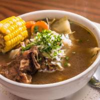 Sopa De Mondongo · Beef tripe soup served with fresh vegetables; yellow corn, green cabbage, sliced carrots, ca...
