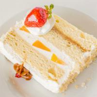 Caramel Fruit Cake · Moist vanilla sponge cake filled with dulce de leche, peaches and chantilly cream.
