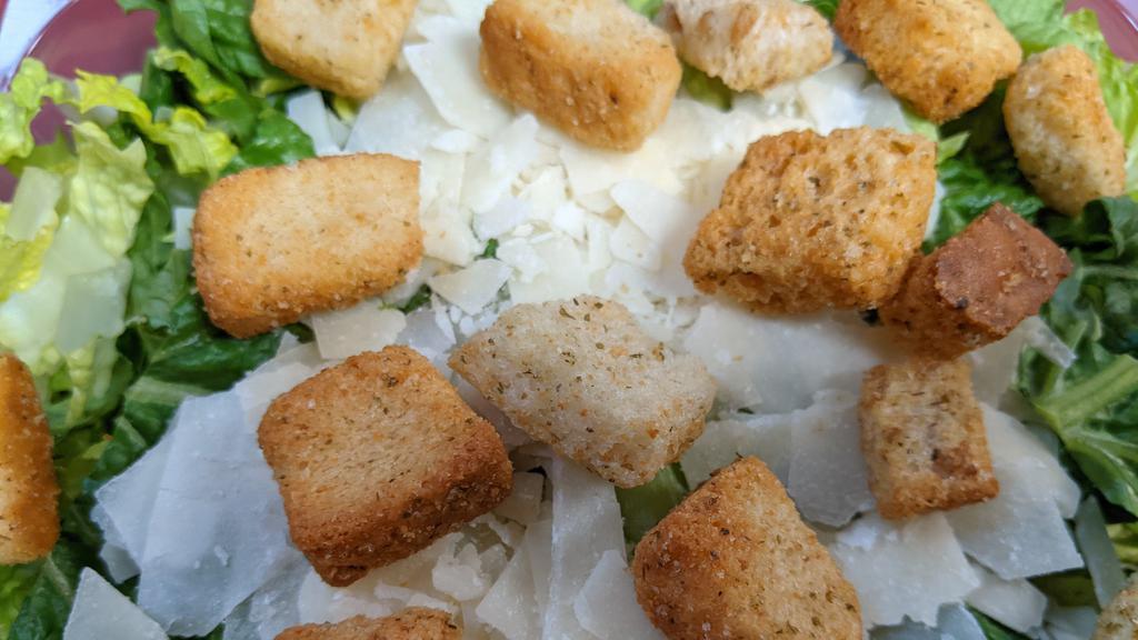 Classic Caesar Salad · Hearts of Romaine, Shaved Parmesan Cheese and Seasoned Croutons.