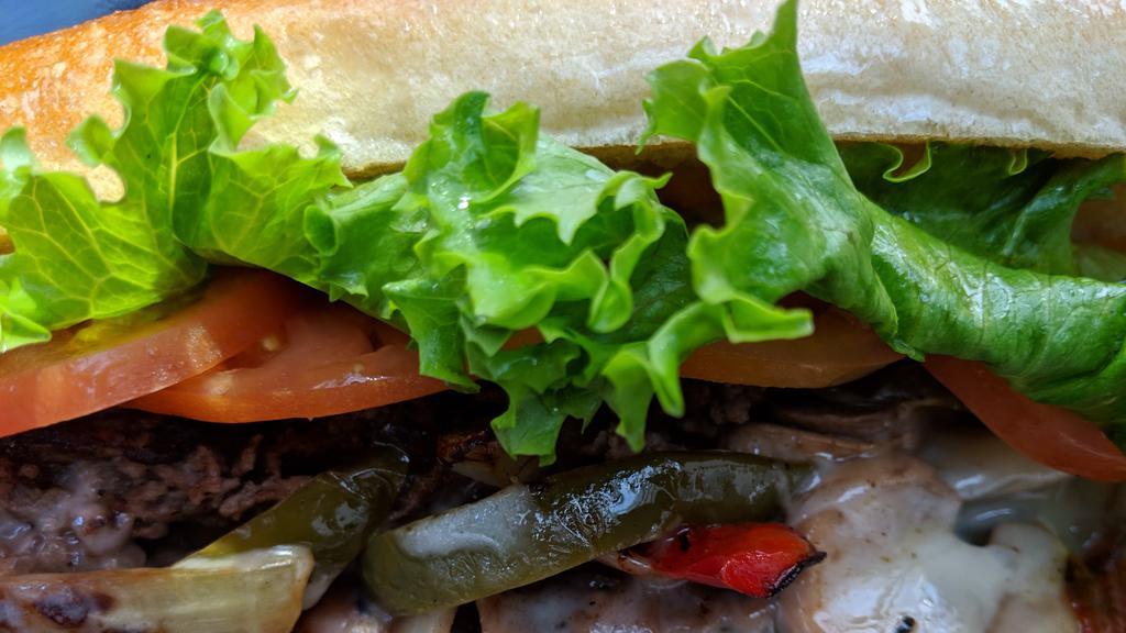 Steak & Cheese Sub · Sliced Sirloin Steak Grilled Hot & Topped with Onions, Peppers, Mushrooms, Provolone Cheese, Lettuce, Tomato & Mayo.