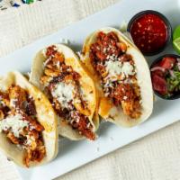 Choripollo Tacos · Marinated chicken, Mexican sausage, and shredded cheese.