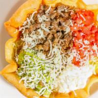 Taco Salad · A crisp flour tortilla shell filled with beans and your choice of either chicken, beef tips ...