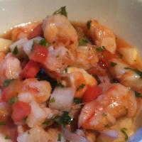 Ceviche Con Tostones · Shrimp in red cold salsa with chopped onions and cilantro, served with fried plantains.