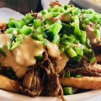 Brisket Cheese Fries · House cut fries topped with beef brisket, Pepper Jack queso, bacon, and fresh jalapeños.