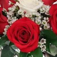 Kisses · Flowers Included:

White Roses: 1
Red Roses: 5
And more filter flowers
Also Included:

Vase ...