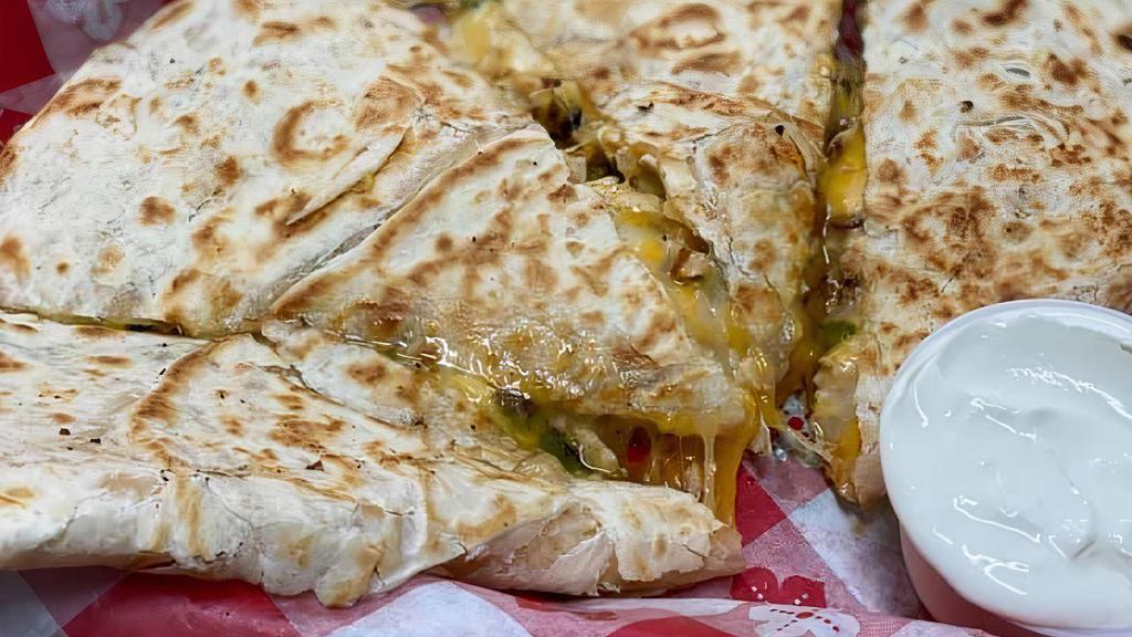Chicken Quesadilla · Grilled chicken in our special spice blend combined with grilled green peppers and onions. Served on a 12